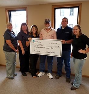 Facebook image: Giving is important to the #bankfamily. Alma is raising funds for a pool slide, so we helped. Wanna bet who tries to go down it first once it gets installed? #community